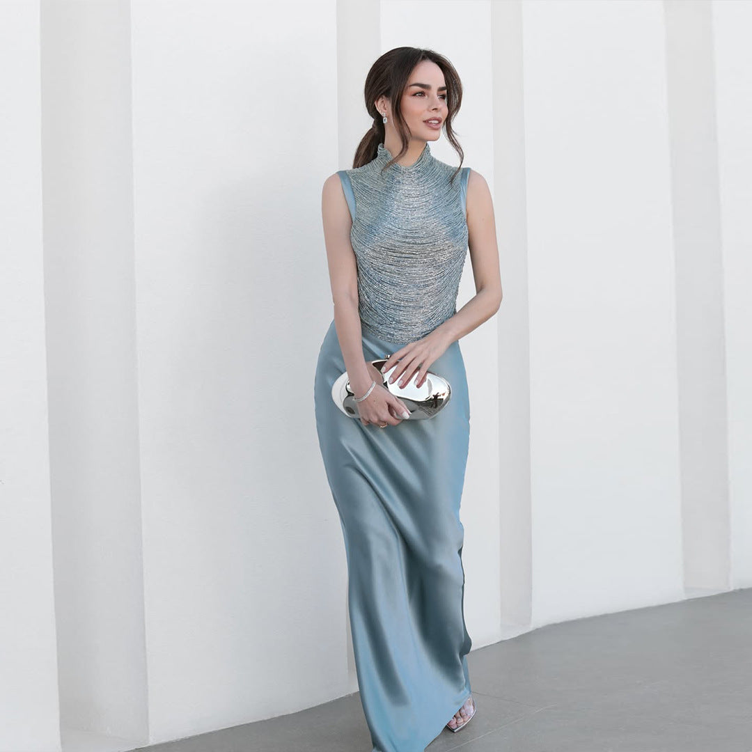 Sleeveless Turtleneck Top With Tassel Detailing Paired With A Satin Midi Skirt by Ricaloux